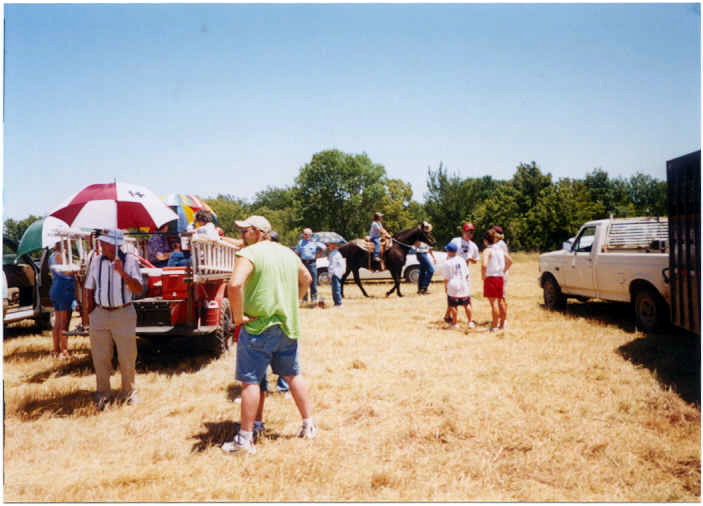 Trail Ride preparations:  Bet McCormick (Class of 1951) with umbrella ready to drive the vintage firetruck in the trail ride.